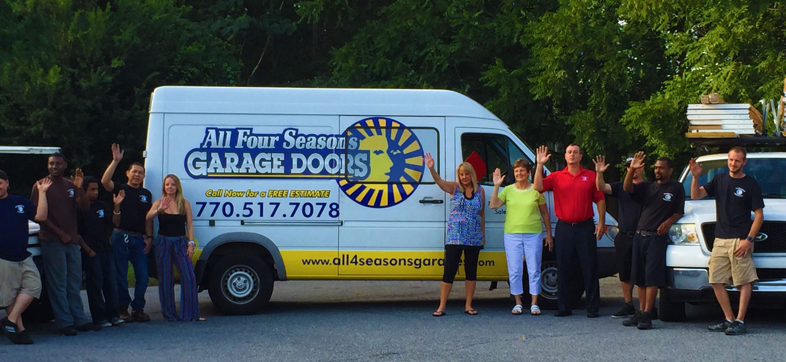 All Four Seasons Garage team standing in front of service vehicles